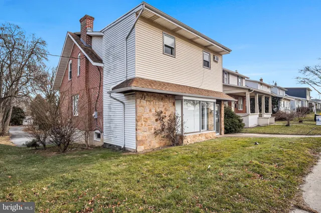 a front view of a house with wooden fence