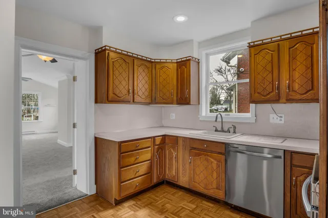 a kitchen with a sink cabinets and window