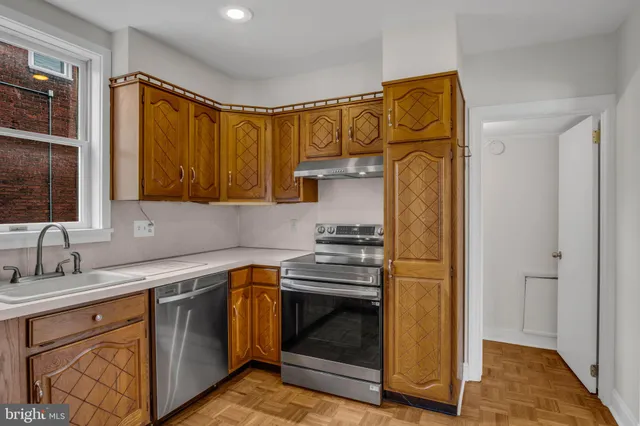 a kitchen with stainless steel appliances granite countertop a stove and a refrigerator