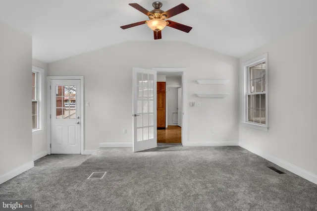 a view of a livingroom with a ceiling fan and window