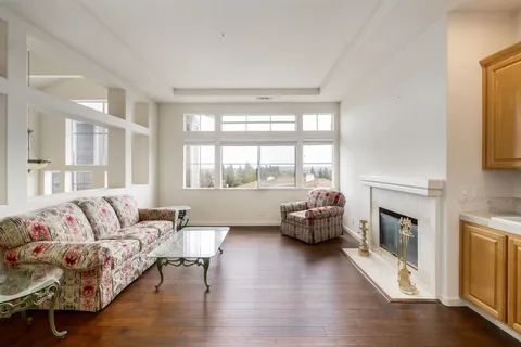 a living room with furniture wooden floor and a fireplace