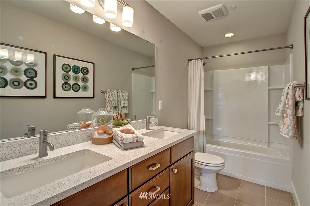 22317 44th Drive Southeast Bothell, WA 98021 - Photo 11 of 14 a bathroom with a granite countertop sink a toilet a shower and a mirror