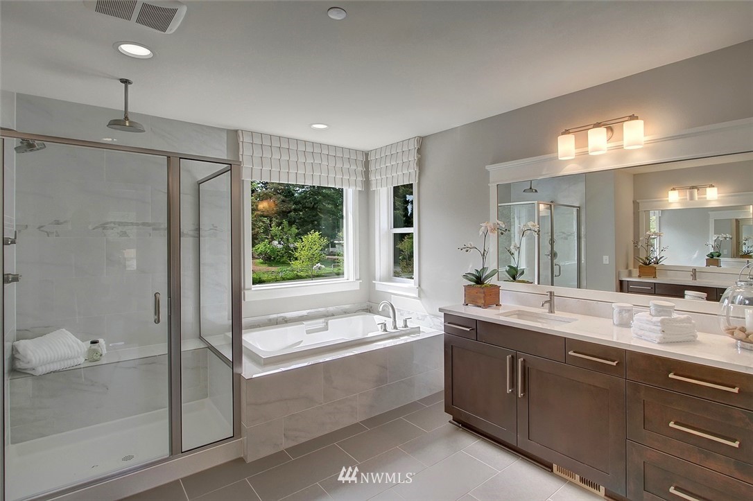 22317 44th Drive Southeast Bothell, WA 98021 - Photo 7 of 14 a bathroom with a double vanity sink mirror and shower