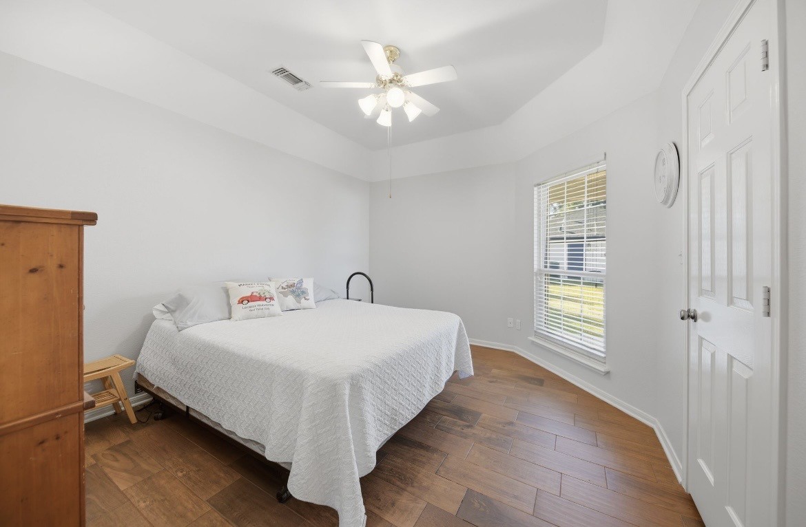 306 Matula Avenue Schulenburg, TX 78956 - Photo 14 of 21 a bedroom with a bed and a chandelier