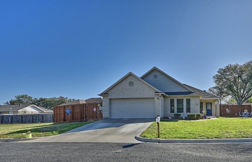 306 Matula Avenue Schulenburg, TX 78956 - Photo 2 of 21 a front view of a house with a yard and garage