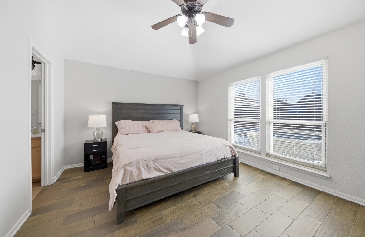 306 Matula Avenue Schulenburg, TX 78956 - Photo 9 of 21 a bed sitting in a bedroom next to a window and a chandelier