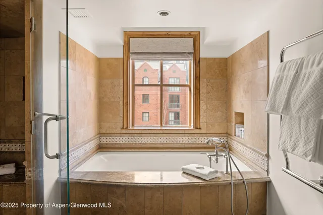 a bath tub sitting next to a window