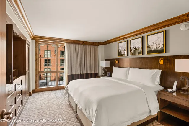 a bedroom with a large bed and a large window