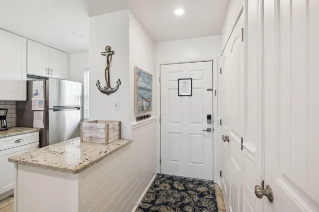 a kitchen with stainless steel appliances kitchen island granite countertop a table and chairs