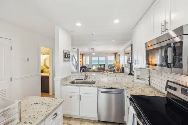 a kitchen with stainless steel appliances granite countertop a stove and a sink