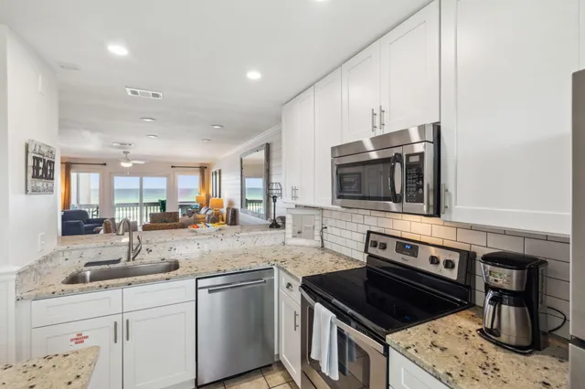 a kitchen with a stove a refrigerator and a sink