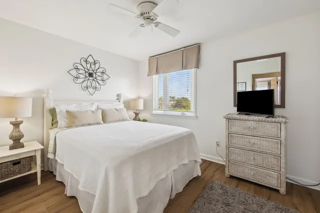 a bedroom with a bed and painting on the wall