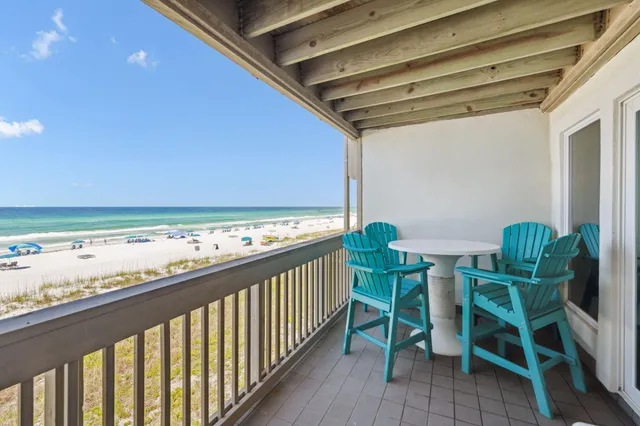 a city view from a balcony with chairs