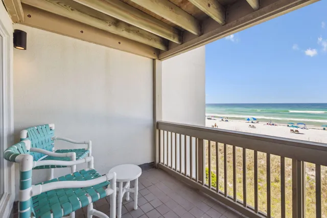 a view of a chairs and table in the balcony