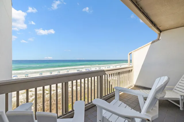 a view of a chair and table in the balcony