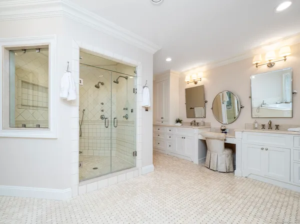 a bathroom with a double vanity sink mirror and shower