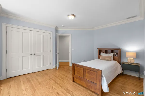 a bedroom with a bed and a night stand