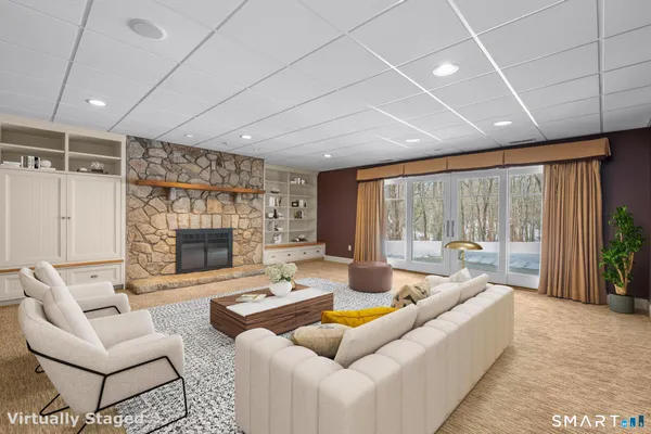 a living room with furniture and a fireplace