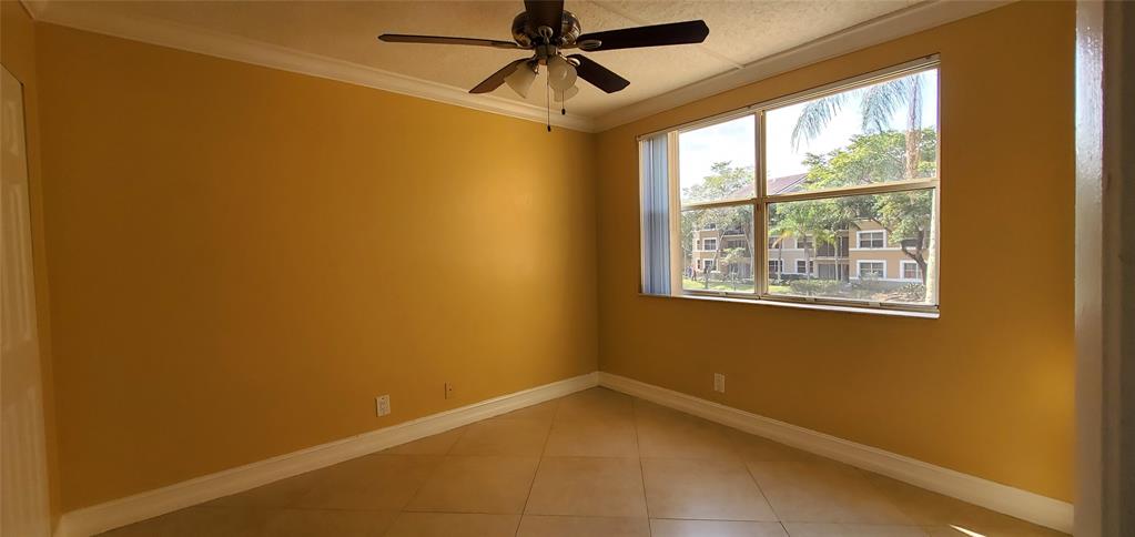 8781 Wiles Road, Unit 202 Coral Springs, FL 33067 - Photo 12 of 20 a view of an empty room with a window