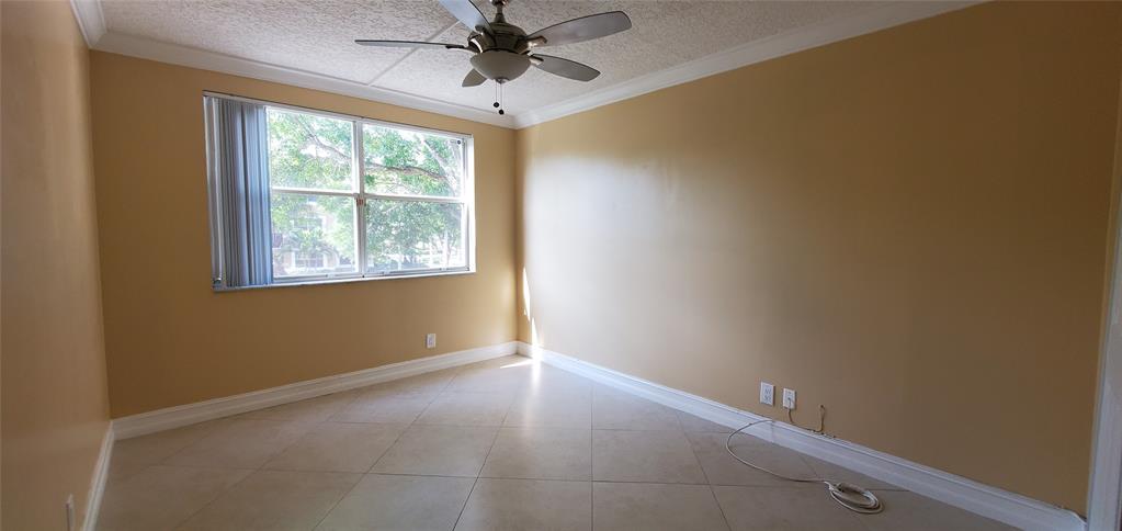 8781 Wiles Road, Unit 202 Coral Springs, FL 33067 - Photo 13 of 20 an empty room with a window