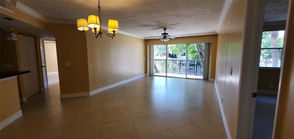 8781 Wiles Road, Unit 202 Coral Springs, FL 33067 - Photo 3 of 20 wooden floor in an empty room with a window