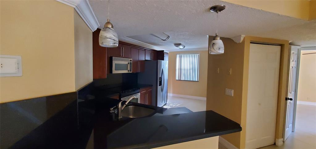 8781 Wiles Road, Unit 202 Coral Springs, FL 33067 - Photo 6 of 20 a view of a hallway with workspace