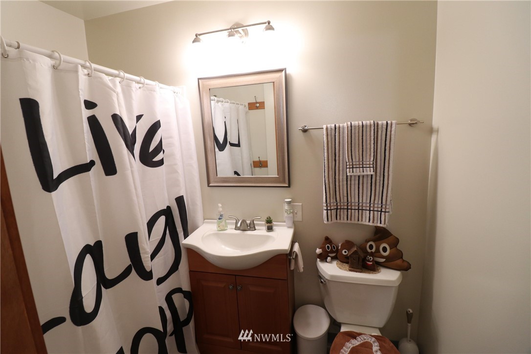 39 Dixon Road Omak, WA 98841 - Photo 28 of 38 a bathroom with a sink a mirror and a toilet