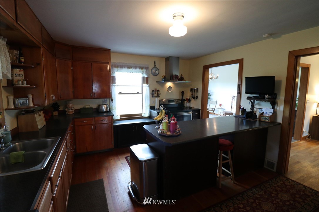 39 Dixon Road Omak, WA 98841 - Photo 29 of 38 a kitchen with sink refrigerator and cabinets