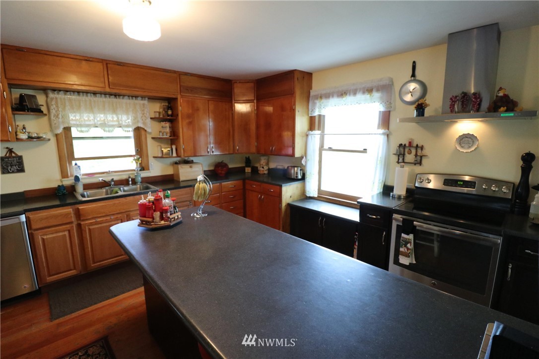 39 Dixon Road Omak, WA 98841 - Photo 31 of 38 a kitchen with a large window and cabinets