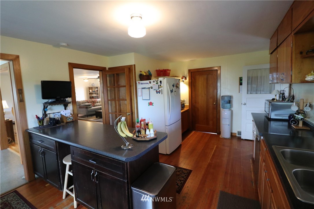 39 Dixon Road Omak, WA 98841 - Photo 33 of 38 a kitchen with sink refrigerator dining table and chairs