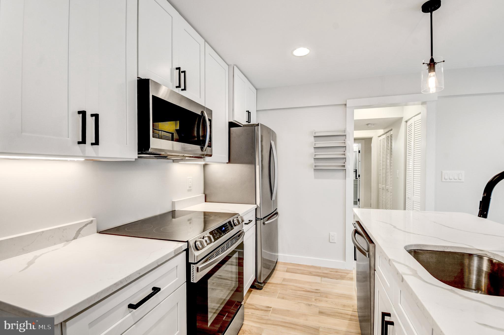 5012 2nd Street Northwest, Unit 2 Washington, DC 20011 - Photo 13 of 30 a kitchen with stainless steel appliances a stove microwave and refrigerator