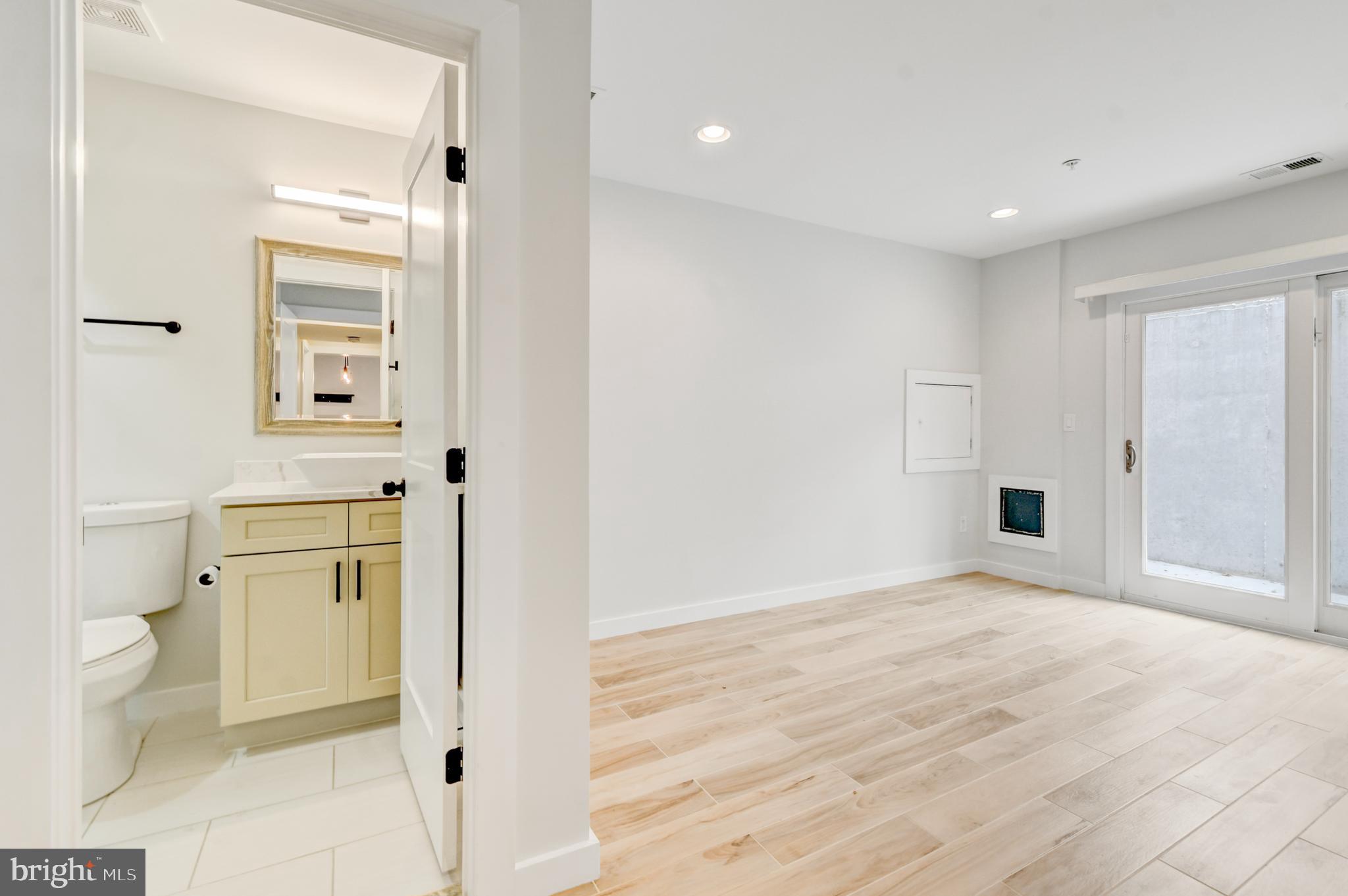 5012 2nd Street Northwest, Unit 2 Washington, DC 20011 - Photo 17 of 30 a view of bathroom with a toilet a sink and a mirror