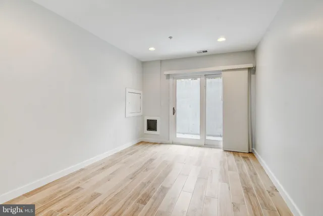 a view of a room with wooden floor