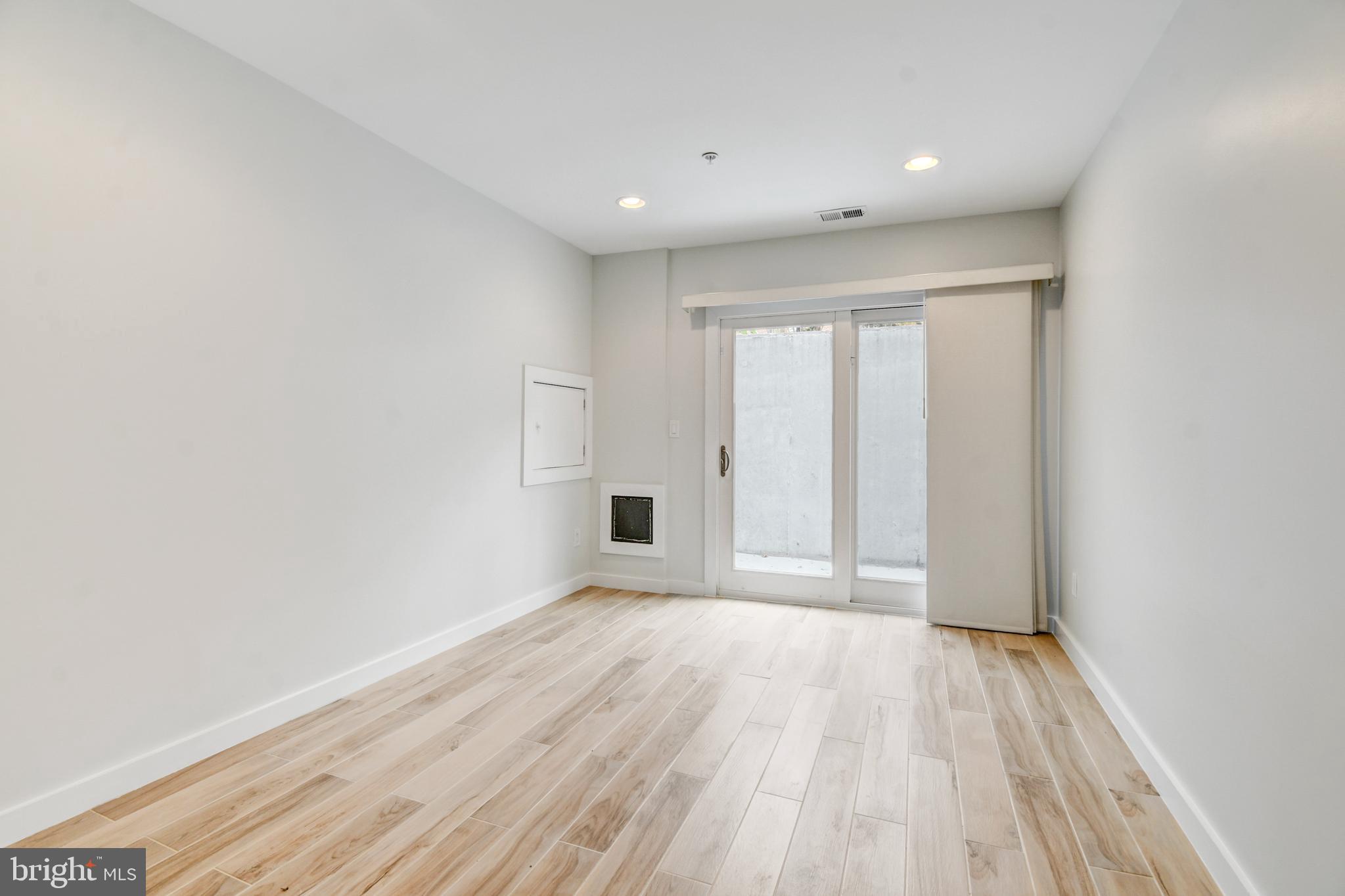 5012 2nd Street Northwest, Unit 2 Washington, DC 20011 - Photo 18 of 30 a view of an empty room with wooden floor and a window