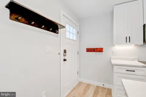a kitchen with stainless steel appliances granite countertop a sink a refrigerator and a counter top space