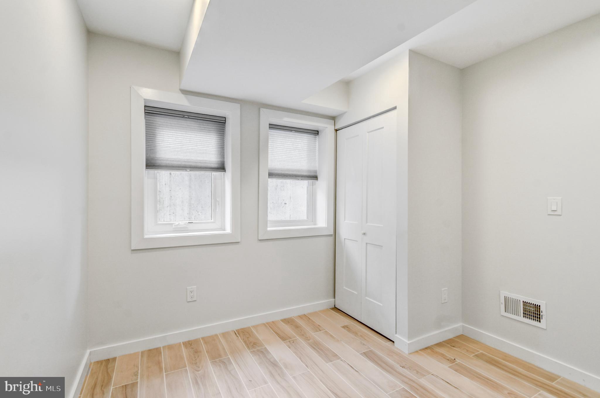 5012 2nd Street Northwest, Unit 2 Washington, DC 20011 - Photo 24 of 30 an empty room with wooden floor and windows