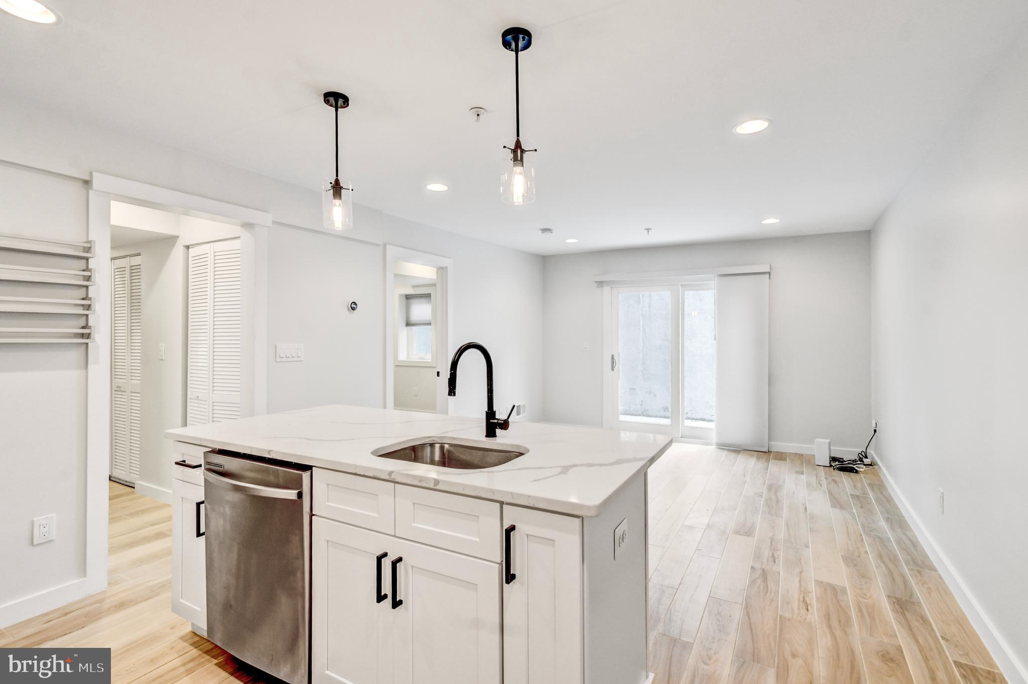 5012 2nd Street Northwest, Unit 2 Washington, DC 20011 - Photo 7 of 30 a kitchen with stainless steel appliances granite countertop a sink a refrigerator and a counter top space