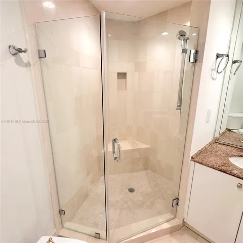 a bathroom with a shower and a sink