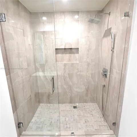 a bathroom with a shower and a sink