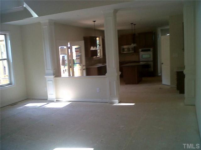 3008 Red Grape Drive Raleigh, NC 27607 - Photo 3 of 6 an empty room with windows and cabinet