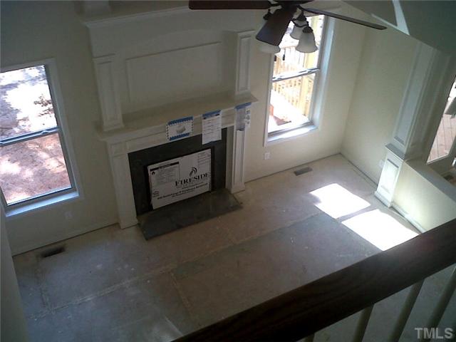 3008 Red Grape Drive Raleigh, NC 27607 - Photo 5 of 6 a living room with a fireplace and a window
