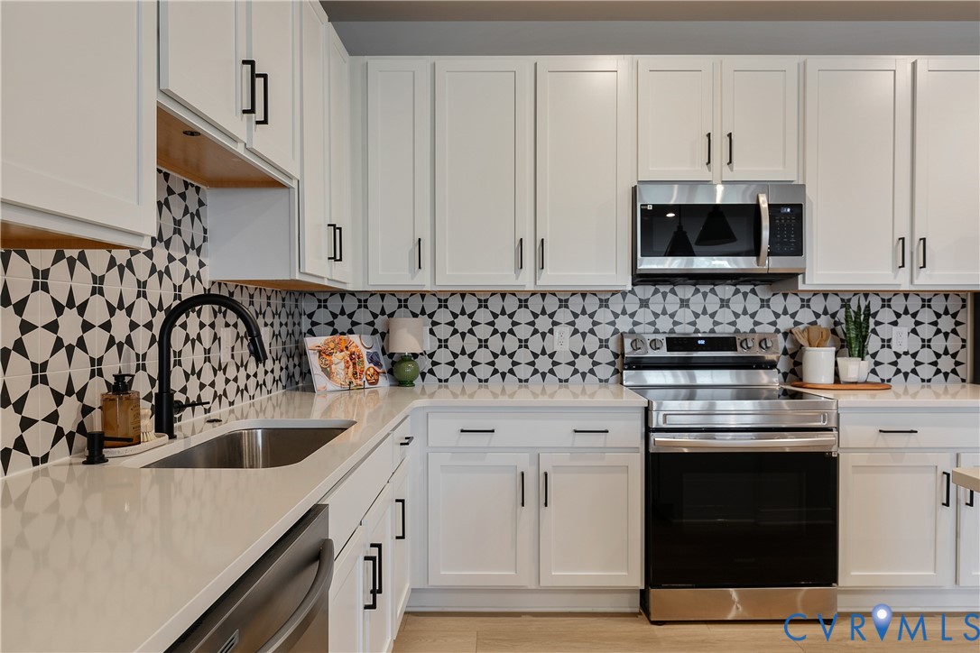 1459 Overbrook Road Richmond, VA 23220 - Photo 11 of 39 a kitchen with a sink stove and cabinets