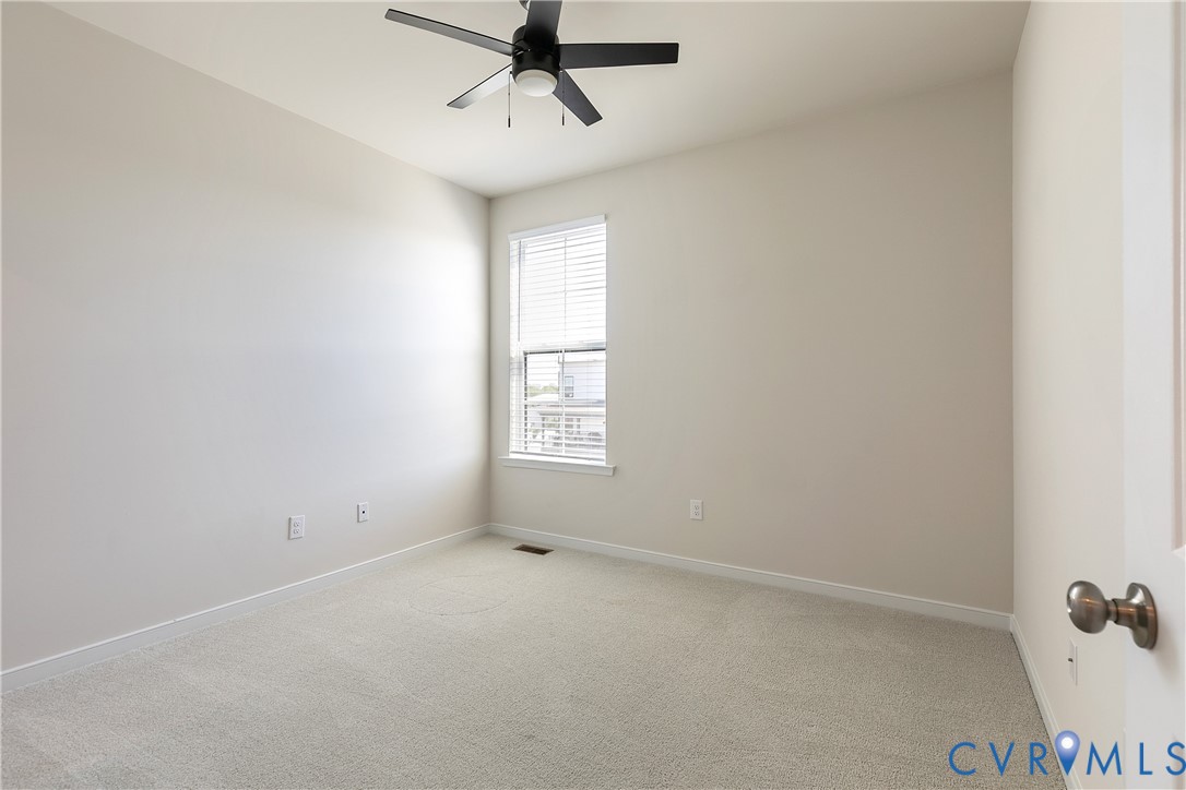 1459 Overbrook Road Richmond, VA 23220 - Photo 31 of 39 an empty room with a window and a fan