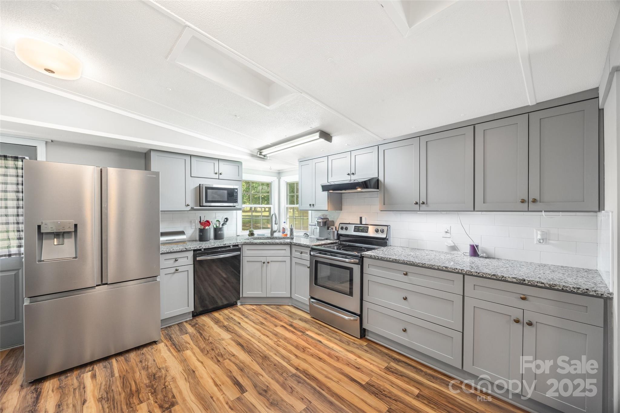 2784 Billy Wilson Road, Unit 15 Rock Hill, SC 29732 - Photo 12 of 33 a kitchen with stainless steel appliances granite countertop a refrigerator sink and stove