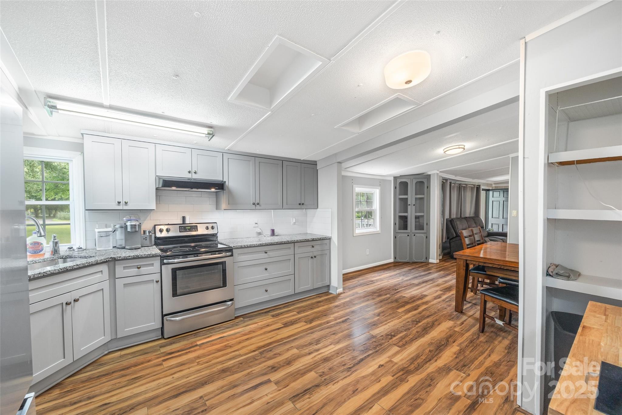 2784 Billy Wilson Road, Unit 15 Rock Hill, SC 29732 - Photo 14 of 33 a kitchen with a stove a sink and wooden floors