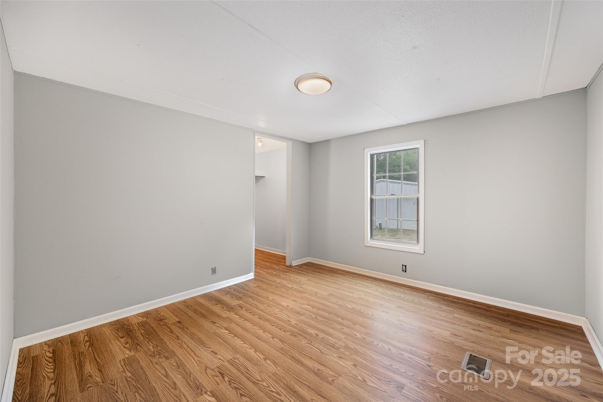 2784 Billy Wilson Road, Unit 15 Rock Hill, SC 29732 - Photo 17 of 33 an empty room with wooden floor and windows