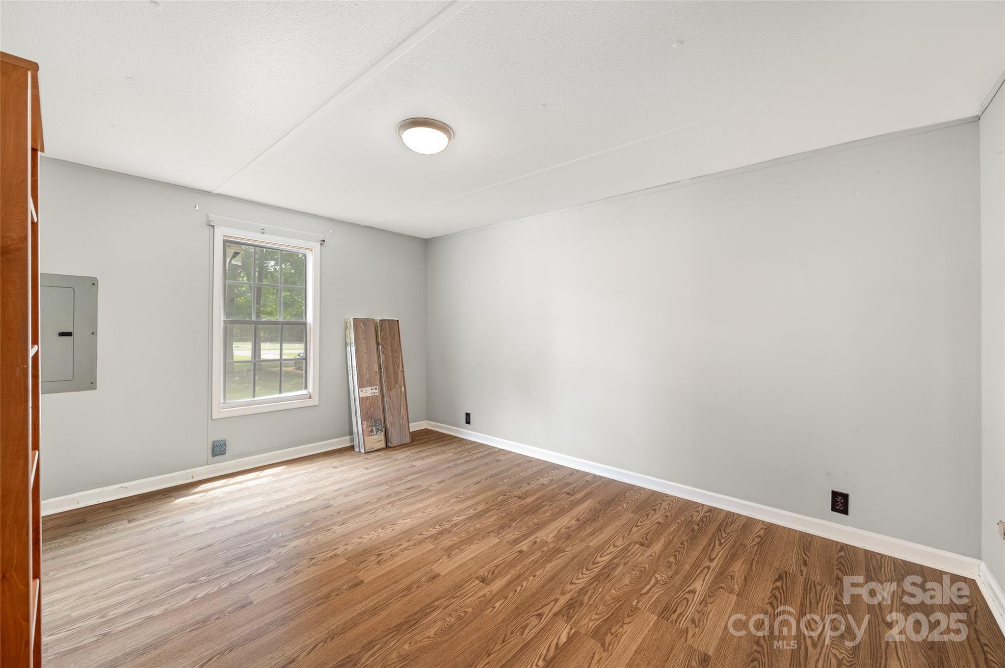 2784 Billy Wilson Road, Unit 15 Rock Hill, SC 29732 - Photo 19 of 33 a view of an empty room with wooden floor and a window