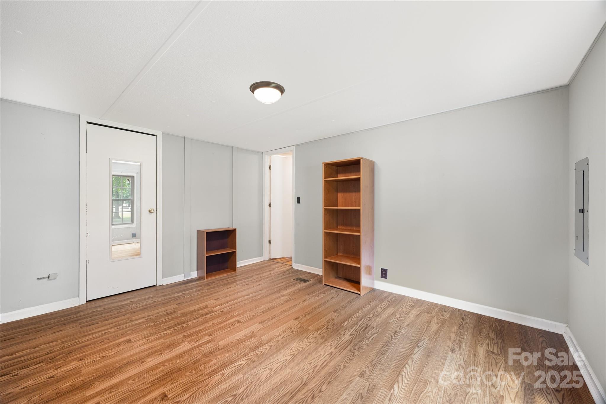 2784 Billy Wilson Road, Unit 15 Rock Hill, SC 29732 - Photo 20 of 33 an empty room with wooden floor and fireplace