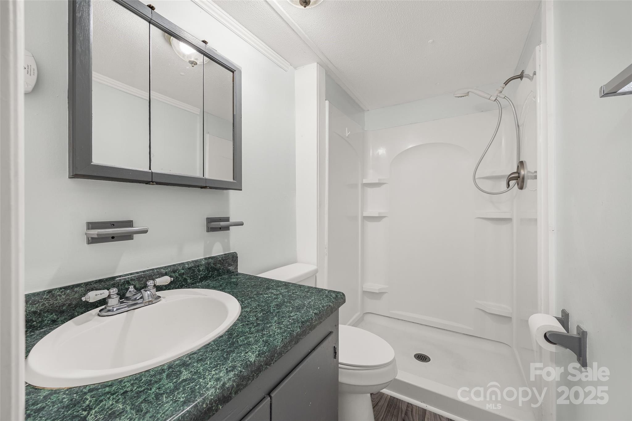 2784 Billy Wilson Road, Unit 15 Rock Hill, SC 29732 - Photo 21 of 33 a bathroom with a granite countertop sink a toilet and shower