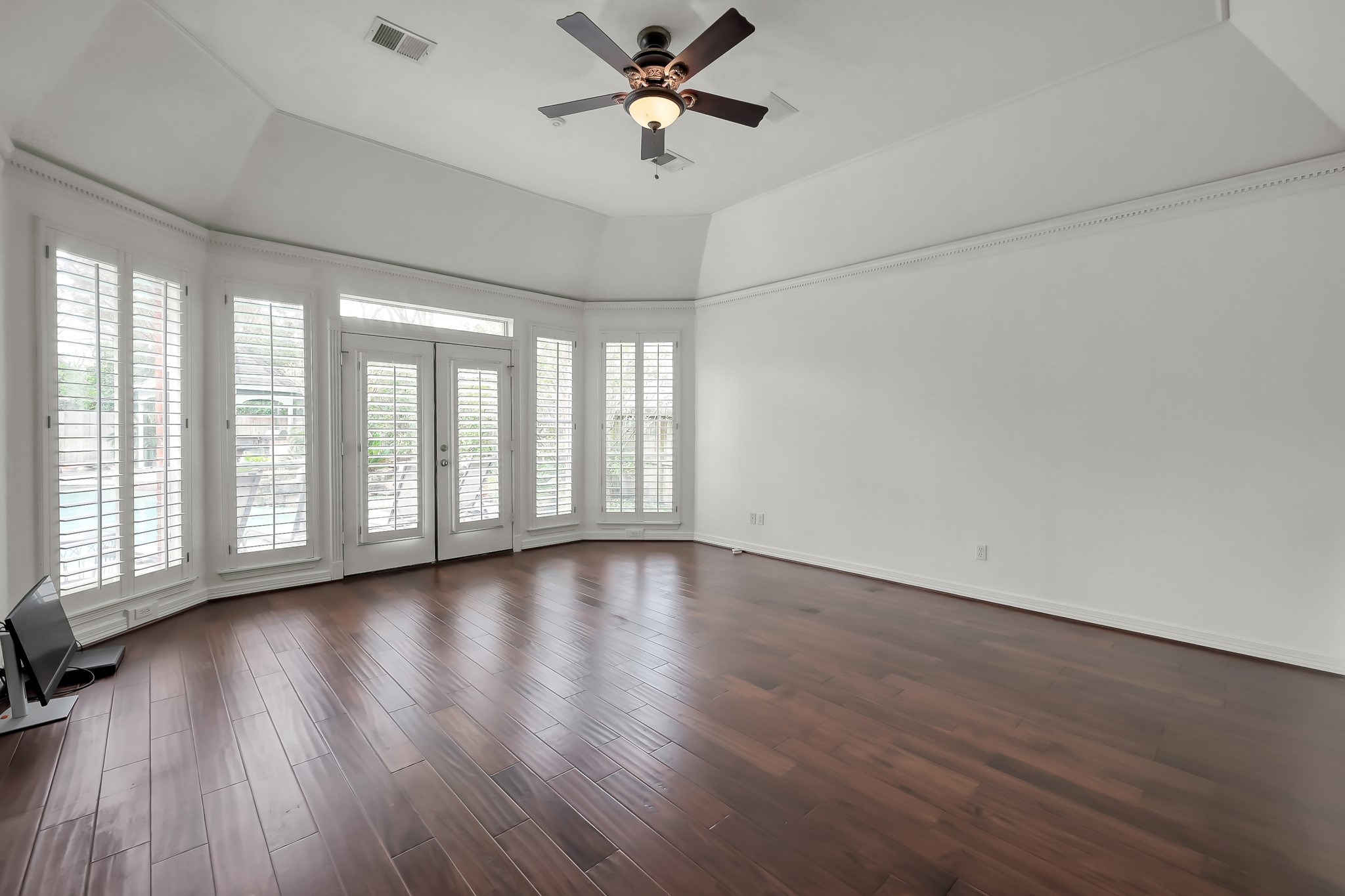 16403 Agusta Court Spring, TX 77379 - Photo 15 of 36 an empty room with wooden floor fan and windows
